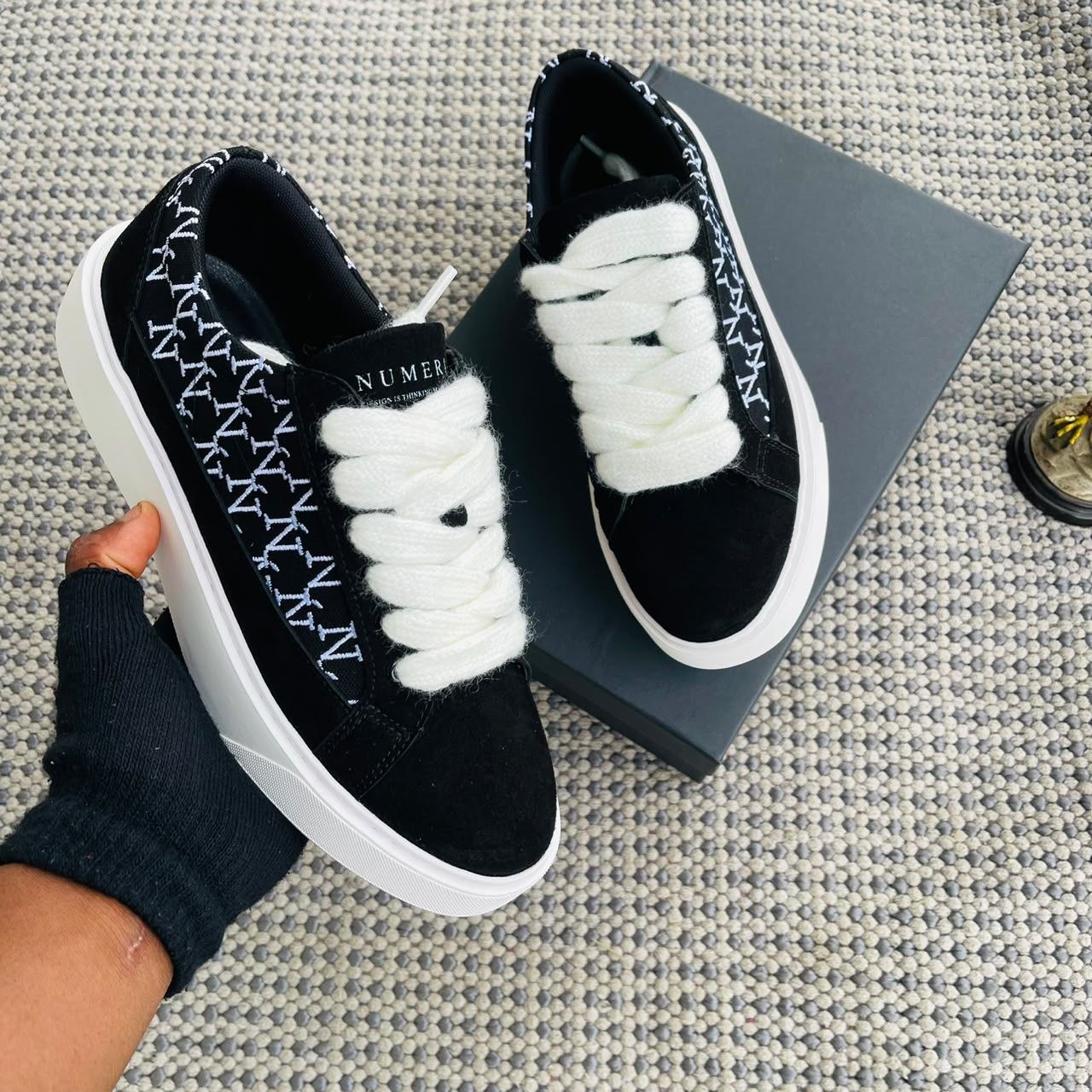 Black and white premium sneakers on a textured surface